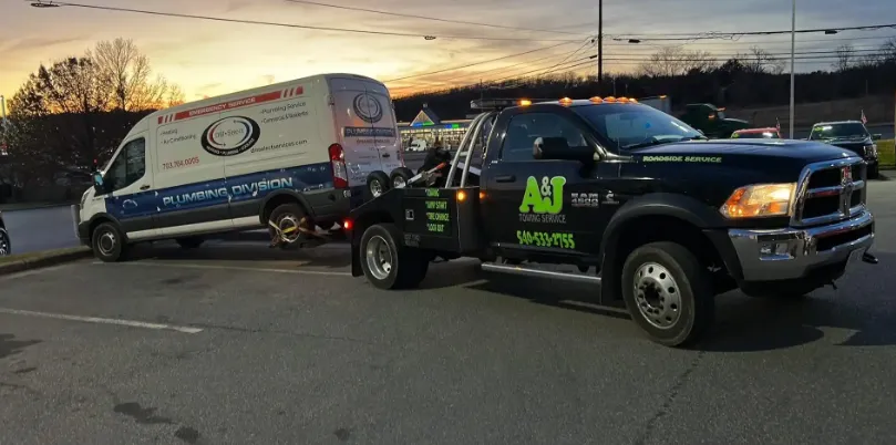 A tow truck parked in a parking lot, ready to assist vehicles in need.
